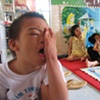 A bright morning at Thien Phuc Ophanage, highlights a caretaker and some of the children that call this place home.