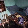 A young child afflicted with Spina Bifida rests at home, Danang
