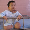 A child plays with a small car in Tu' Du' hospital.  He will live his life in a ward here, in downtown Ho Chi Minh City.