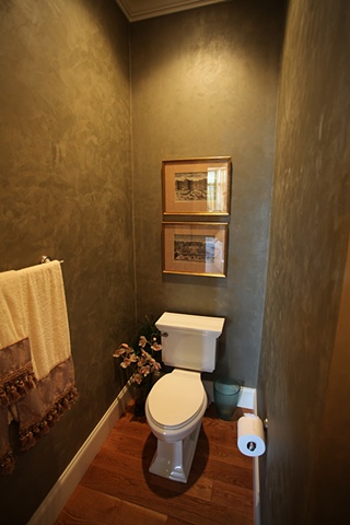 Burnished green plaster in powder room.