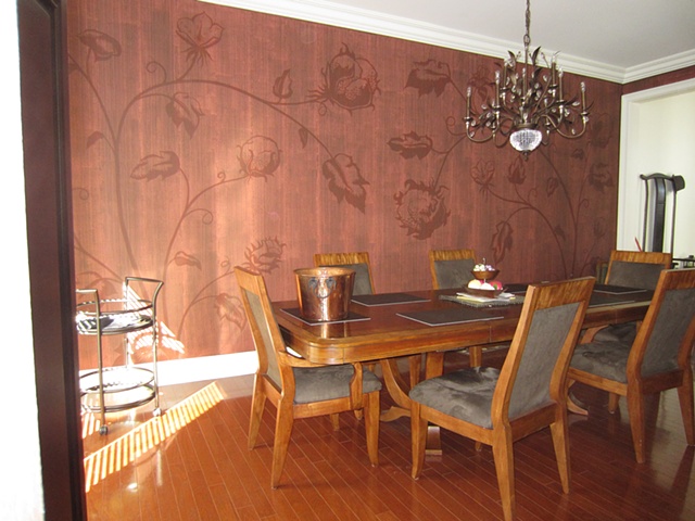 Freehand cotton plant motif with matte plaster striae overlay in dining room.