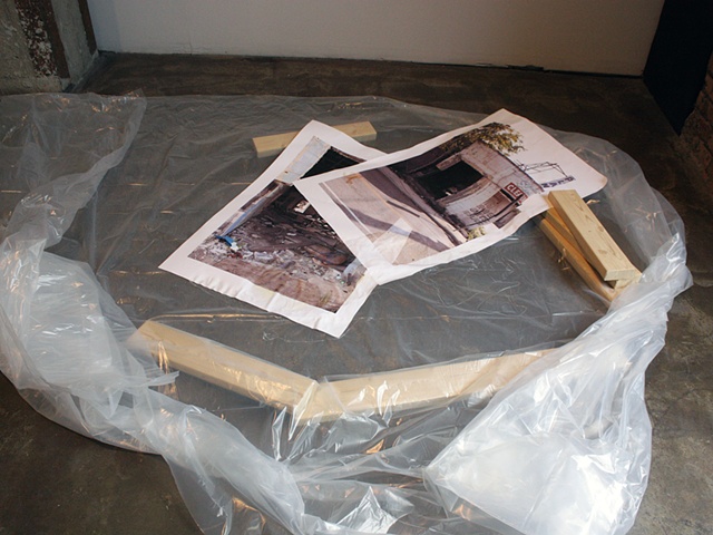 sculpture of photograph in artificial puddle with fake 2x4s by Rena Leinberger at Smack Mellon