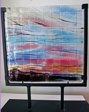 Pink and Blue sky over Mountains
in wrought iron metal stand
details:
glass piece comes in wrought iron metal stand. total size is 14" tall x 11" wide