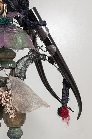 "In Mute Witness at the outskrits and out of center she forms a final creased edge of makeshift settlements, a dark and iridescent thorn of horn pierces all home with the hard and the green of unripe fruit"