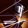 Light reflecting off three mirrors
