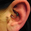 Daith piercing with 16gauge captive bead ring with 4mm black opal bead from Industrial Strength and rook piercing with 18gauge implant-grade titanium curved barbell from Neometal
