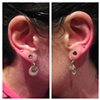 paired upper-earlobe piercings with 18gauge implant-grade titanium barbells with 2.5mm prong-set cubic zirconia from Neometal