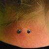 fresh nape piercing with 14gauge implant-grade titanium surface bar with 4mm Capri Blue opals from Industrial Strength