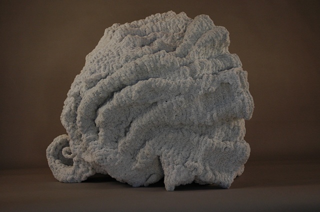 Chenille stem sculpture in the shape of a shell, inspired by the marble fountains of Rome.