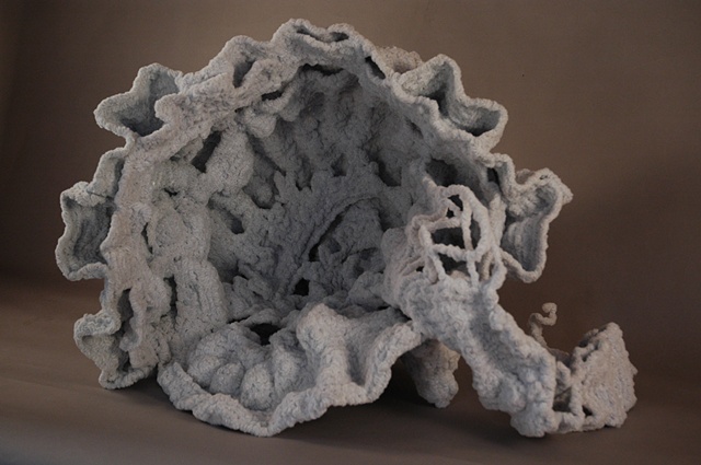 Chenille stem sculpture in the shape of a shell, inspired by the marble fountains of Rome.