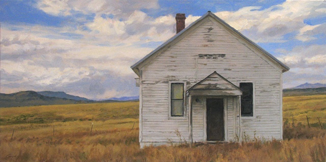 White schoolhouse from front, open fields, clouds, distant hills