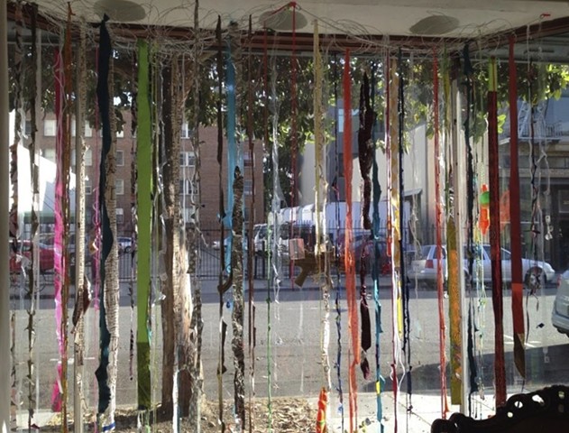 INTALLATION ART- toy guns, miniature military guns in vintage baseball card sleeves, rope, fiber, ribbon, tape, twine and plastic hanging from aluminum wire sculptures