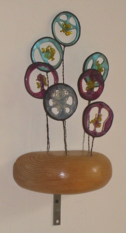 recycled construction lumber, wire, colored glass scraps.
