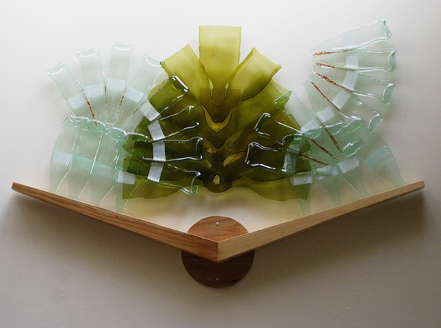 Glass rests in wood chevron.  Includes red frit.