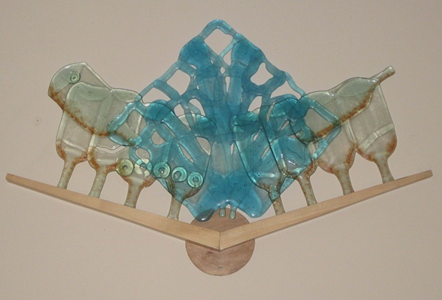 Glass rests in wood chevron.  Includes red frit.