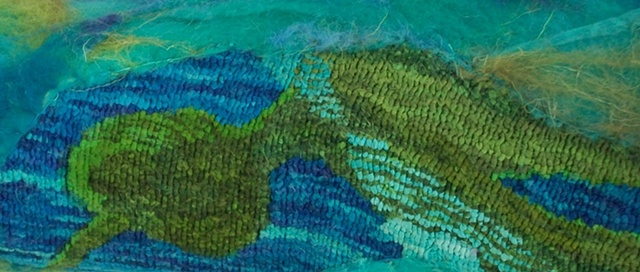 woven reed basket with felted wool and silk surface