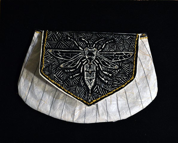 a paper clutch handbag sculpture with a wasp image and swarovski crystals in a shadow box. Art work by Emily Chase