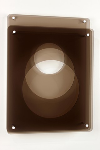 Brown and white laser-cut acrylic geometric abstraction.