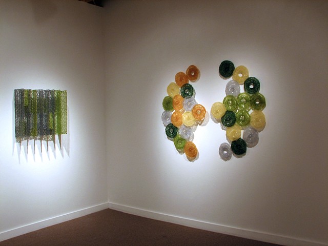 Minimal geometric crocheted fiberglass and polyester resin wall sculpture based on Grid Pi and Pascal's Triangle by Yvette Kaiser Smith