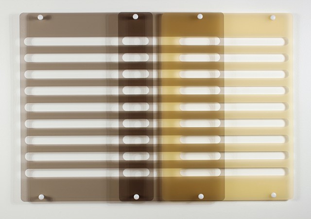 Geometric brown and yellow laser-cut acrylic sheet with spacers.