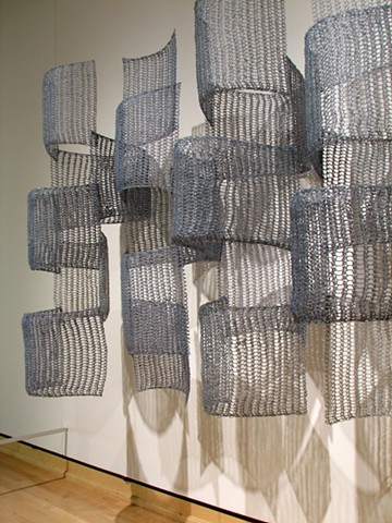 Organic geometric grid crocheted fiberglass and polyester resin wall sculpture based on Pi by Yvette Kaiser Smith