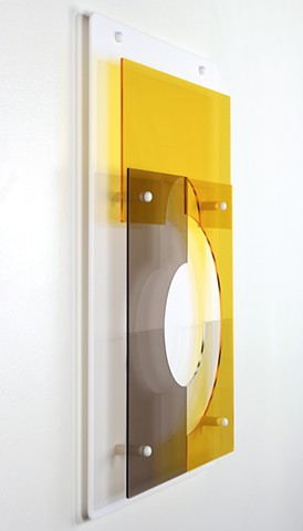 Geometric abstraction in laser-cut acrylic, white, brown, and yellow.