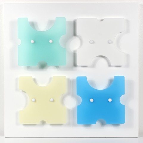 Geometric yellow, white, and blue laser-cut acrylic sheet with spacers.