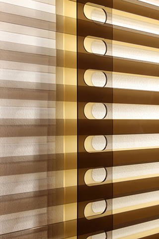 Geometric brown and yellow laser-cut acrylic sheet with spacers.