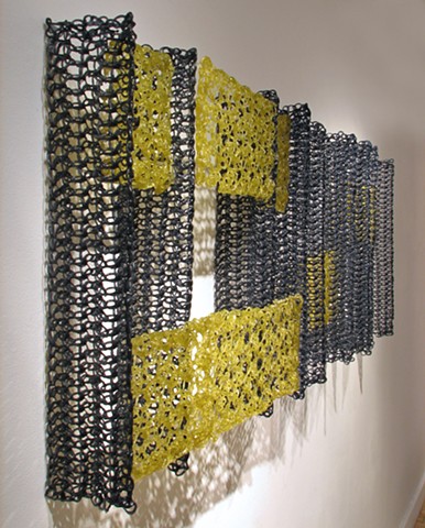 Minimal geometric crocheted fiberglass and polyester resin wall sculpture based on Pi by Yvette Kaiser Smith