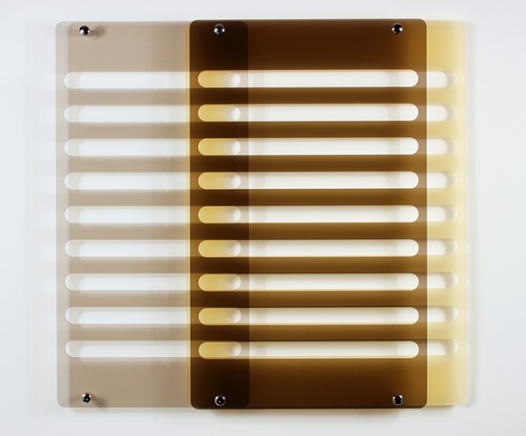 Geometric brown and yellow laser-cut acrylic sheet with spacers.