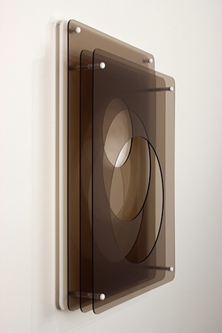 Brown and white laser-cut acrylic geometric abstraction.