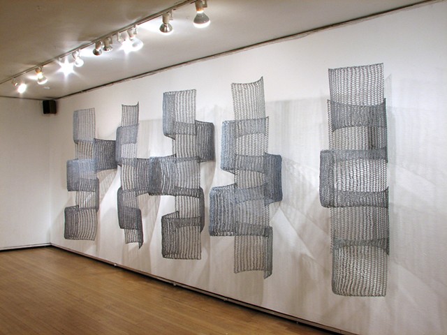 Organic geometric grid crocheted fiberglass and polyester resin wall sculpture based on Pi by Yvette Kaiser Smith