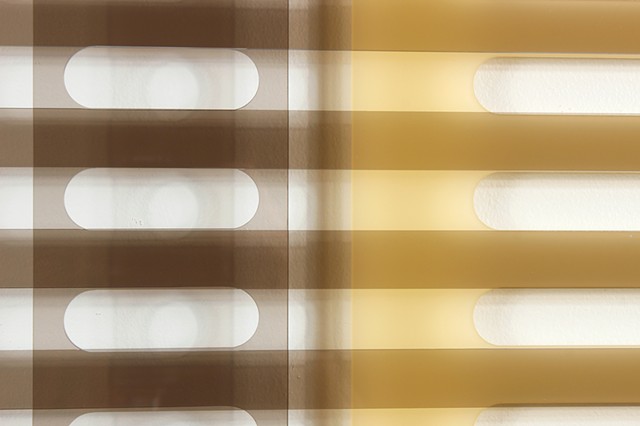 Geometric brown and yellow laser-cut acrylic sheet with spacers.
