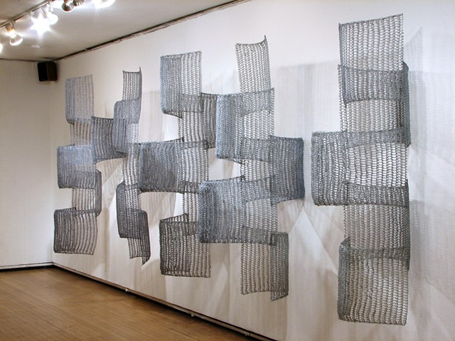 Organic geometric grid crocheted fiberglass and polyester resin wall sculpture based on Pi by Yvette Kaiser Smith