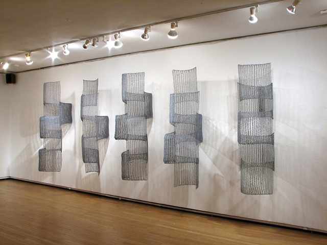 Organic geometric grid crocheted fiberglass and polyester resin wall sculpture based on Pi by Yvette Kaiser Smith