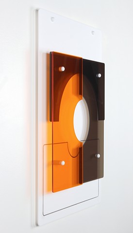 Geometric abstraction in laser-cut acrylic, white, brown, and orange.