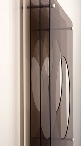 Brown and white laser-cut acrylic geometric abstraction.