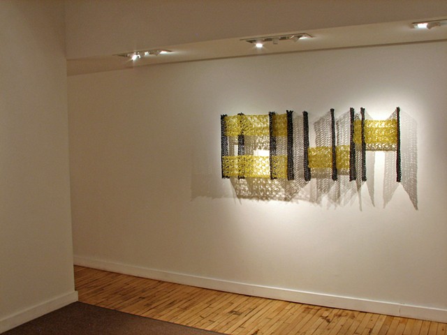 Minimal geometric crocheted fiberglass and polyester resin wall sculpture based on Pi by Yvette Kaiser Smith