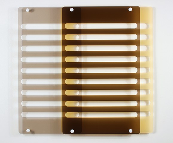 Geometric brown and yellow laser-cut acrylic sheet with spacers.