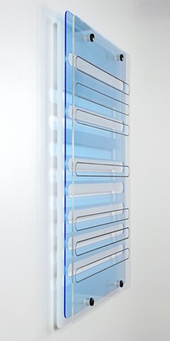 Geometric blue, white, and clear laser-cut acrylic with graphite and nylon spacers.
