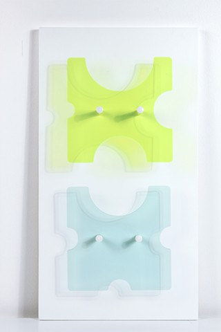 Geometric green and blue laser-cut acrylic sheet with spacers.