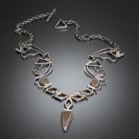 Bib-style geometric necklace with sterling silver, 18 and 14 karat gold, yellow diamonds, green garnets, pyrite