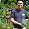 Student with finished mosaic garden art 