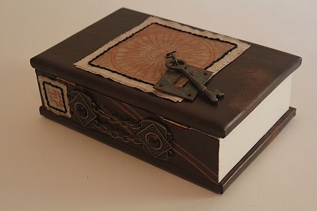 Book sculpture from found box and objects.
