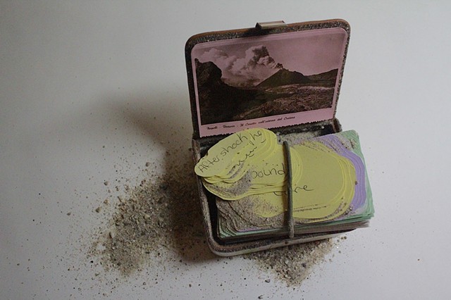 Carved book erupting from the 'earth'.